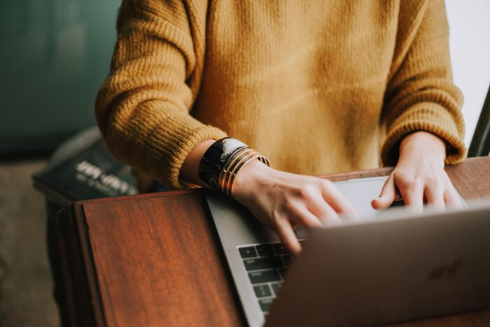 women typing on a laptop