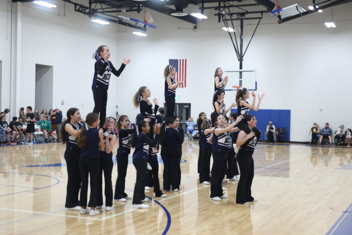 Members of the Great Hearts Roosevelt Spirit Squad doing stunts