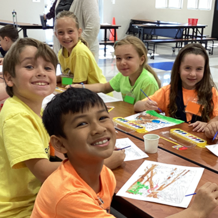 group of summer camp kids at art table