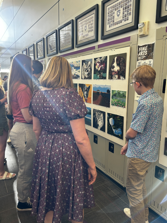 Students viewing artwork at Veritas Art Walk