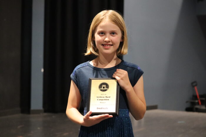 The 2024 Great Hearts Bard, Elinor P., with her plaque