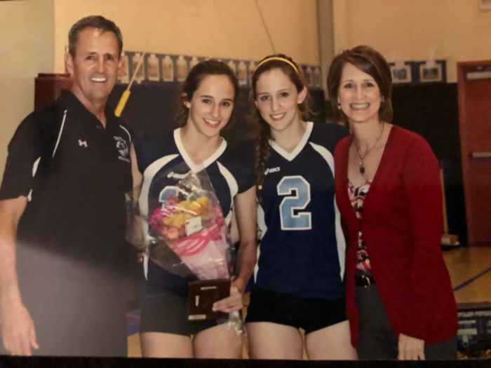 Sarah Sponcil in Veritas Prep Volleyball uniform with her sister and parents.
