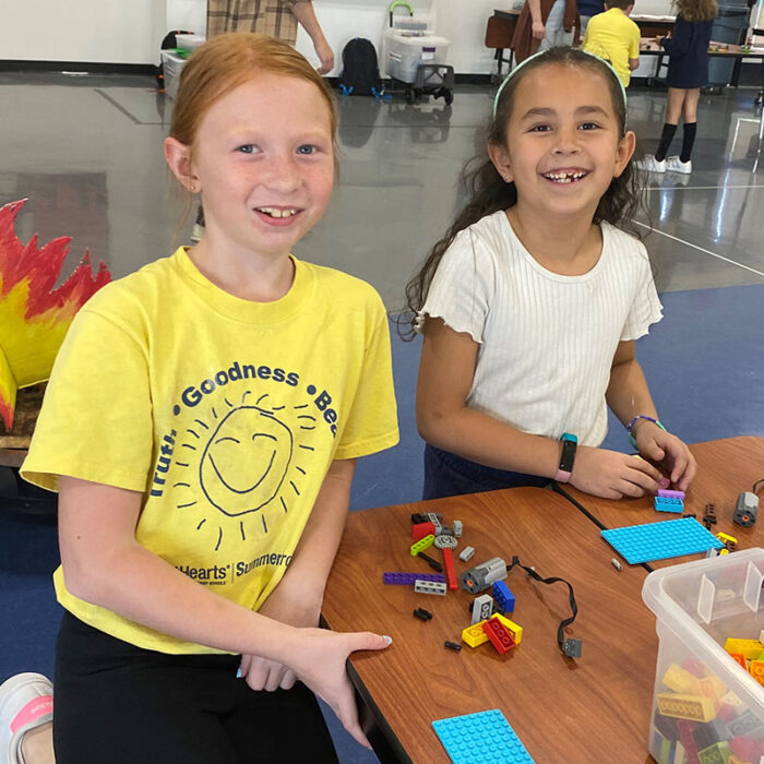 Two summer camp students at a lego table