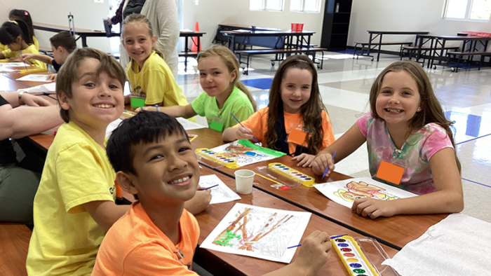 group of summer camp kids at art table