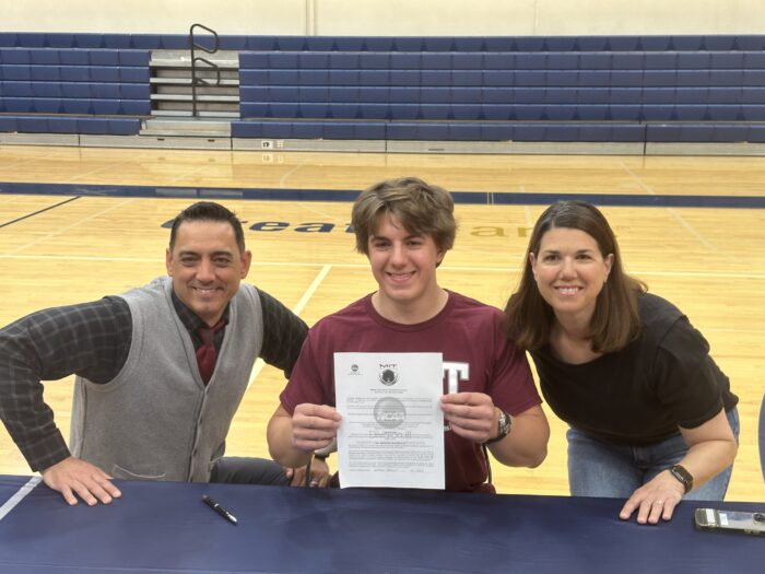Scottsdale senior with his family after signing his Letter of Intent to play college football at MIT.