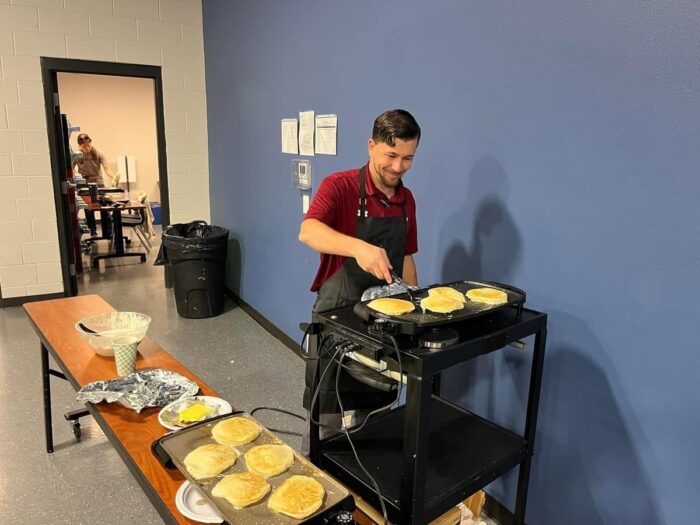 Headmaster making pancakes