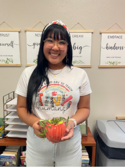 Ms. Lam holding a small plant