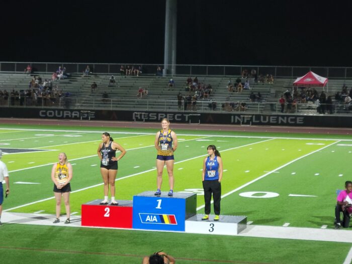 Sofia receiving first place at AIA track meet