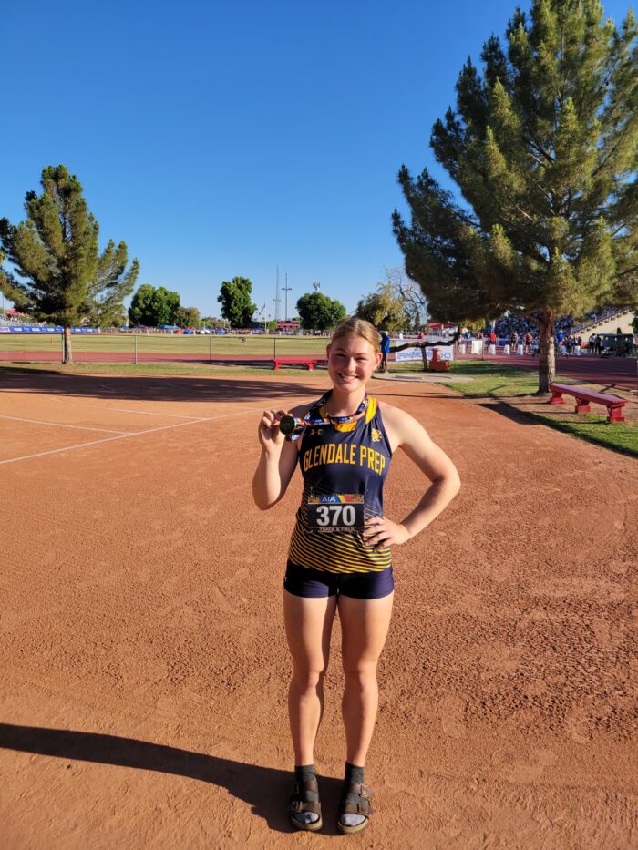 Sofia on a track showing her medal