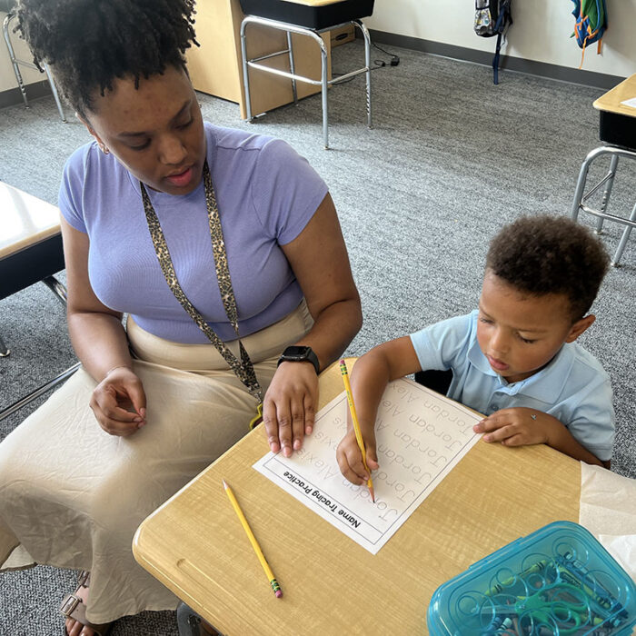 Teacher helping student at Harveston Kinder Readiness Program