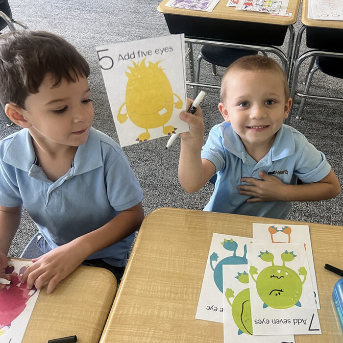 Two students with artwork at Harveston Kinder Readiness Program