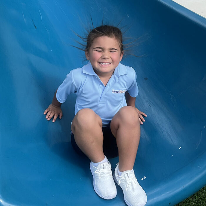 Student coming down slide at Harveston Kinder Readiness Program