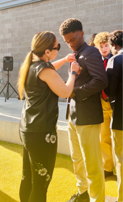 Student receiving a pin on their blazer