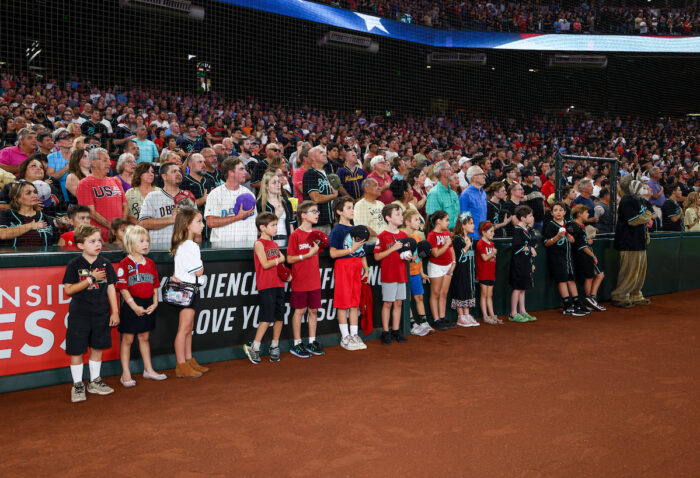 Students on the field during national anthem at Chase Field.