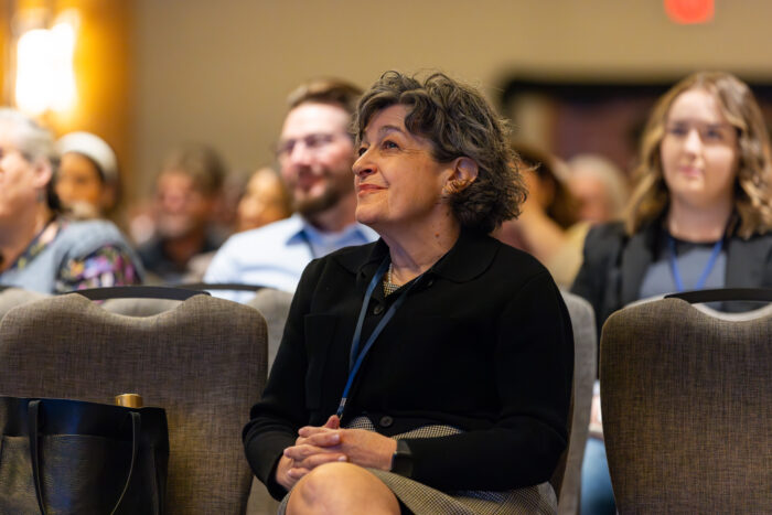 Woman sitting in an audience.