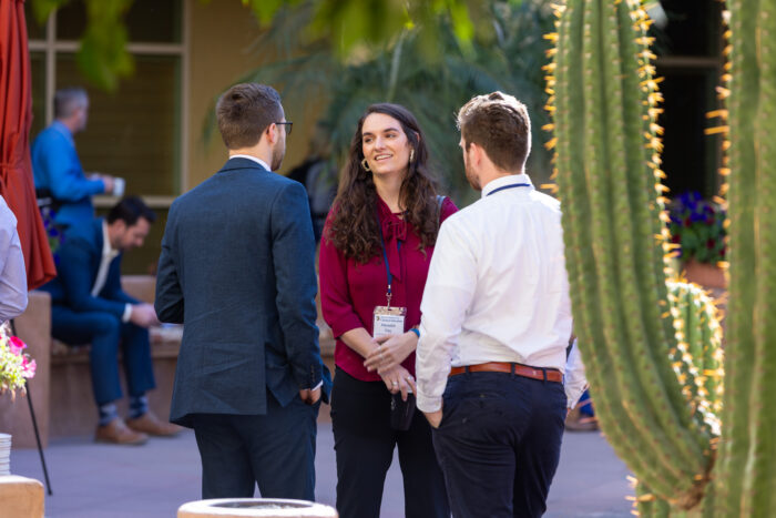People talking in an outdoor courtyard.