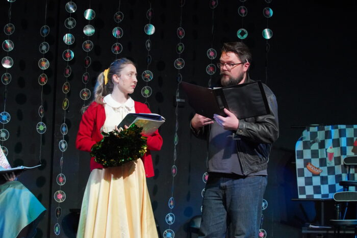 Two faculty actors in 50's costumes on stage