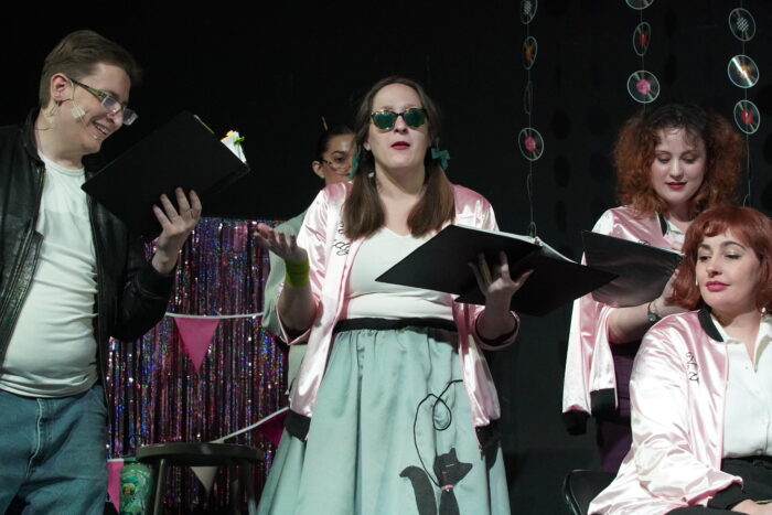 Faculty actors in 50's costumes on stage