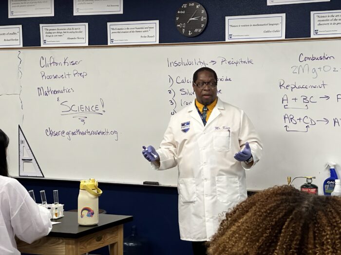 Science teacher in front of their class.