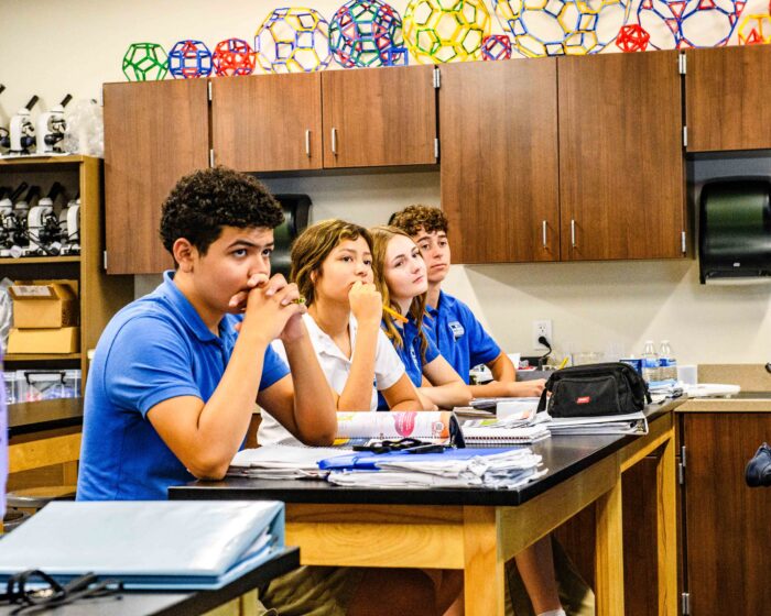 Students sitting at a table in a science room