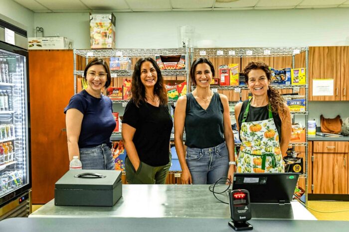 Four parent-volunteers in a lunch room