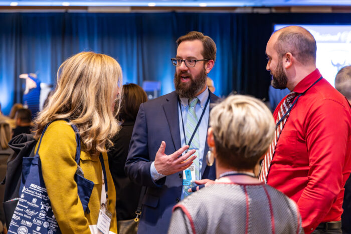 Group of four adults in a discussion.
