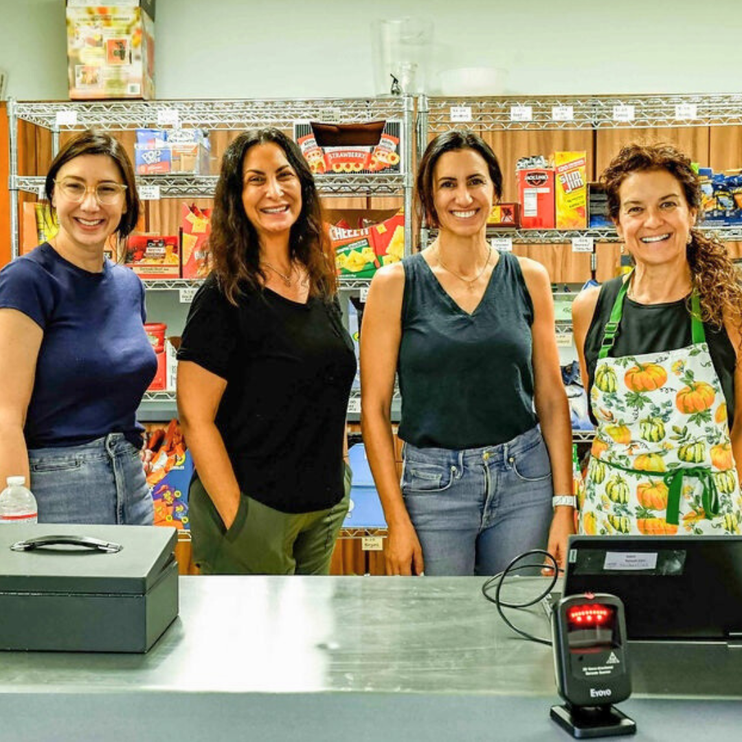 Four parent-volunteers in a lunch room