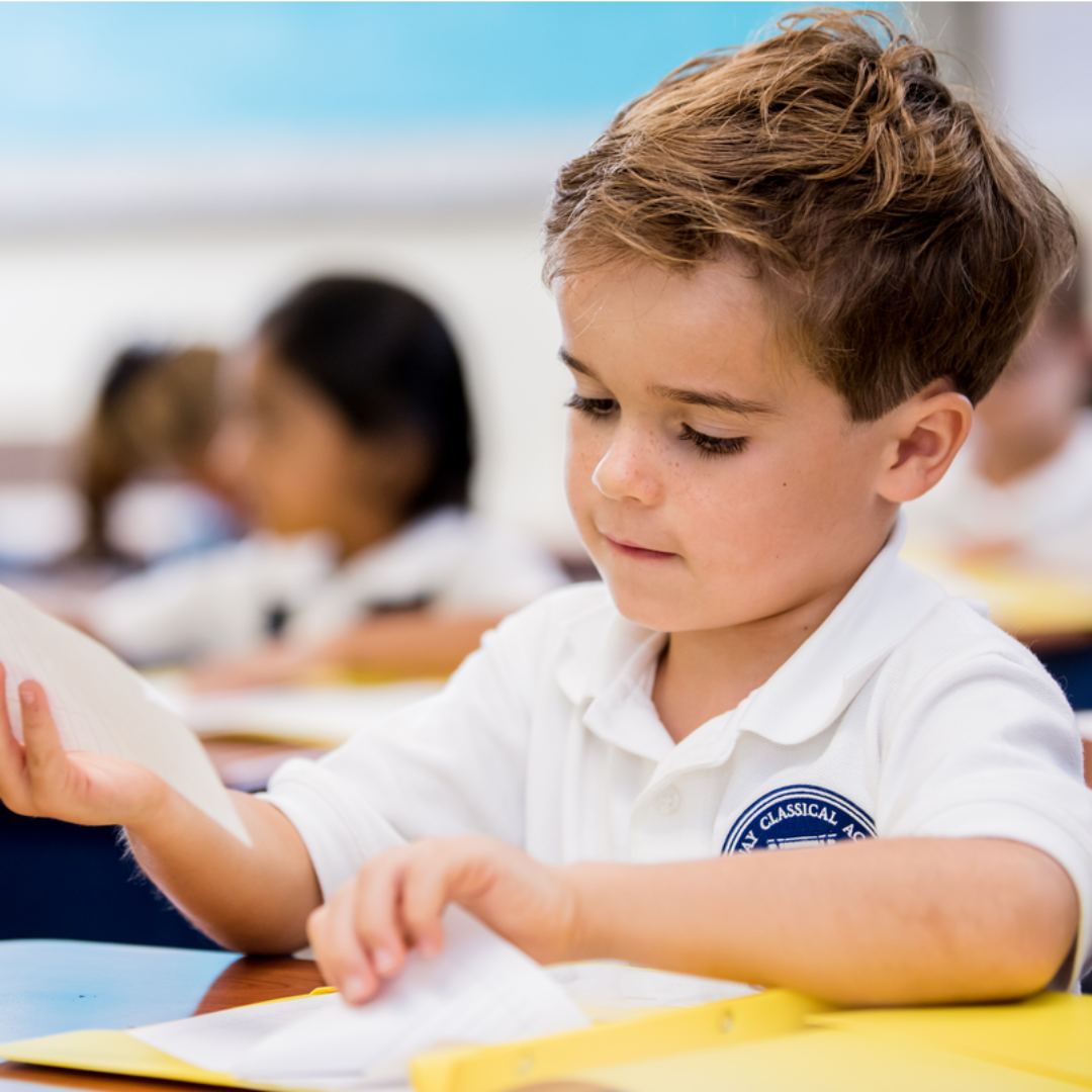 Boy at a desk.