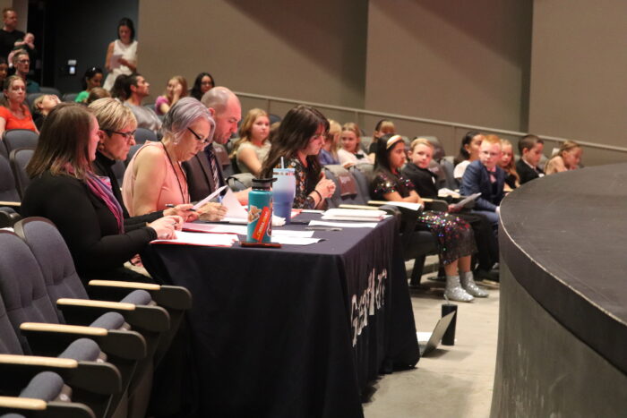 Judges at a table making notes.