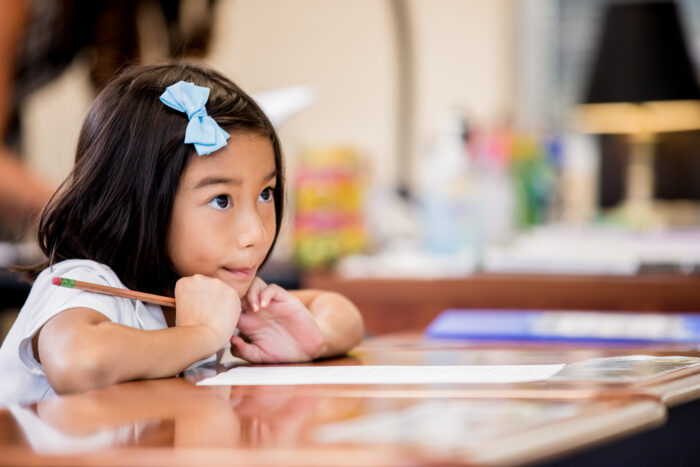 Young girl doing school work at desk