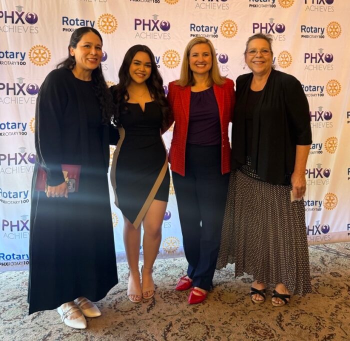 Four-women-standing-together-at-awards-luncheon