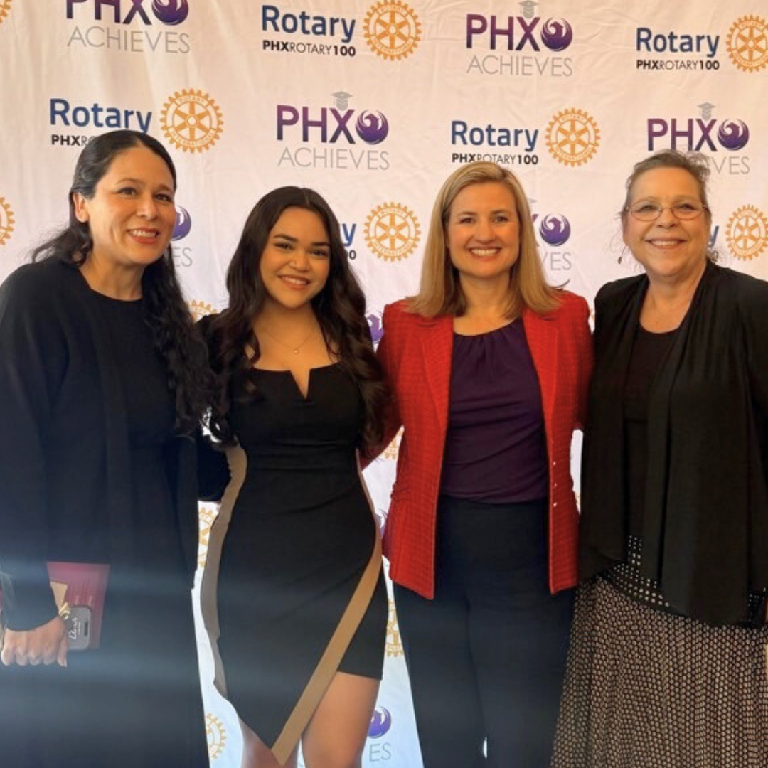 Four women standing together at awards luncheon