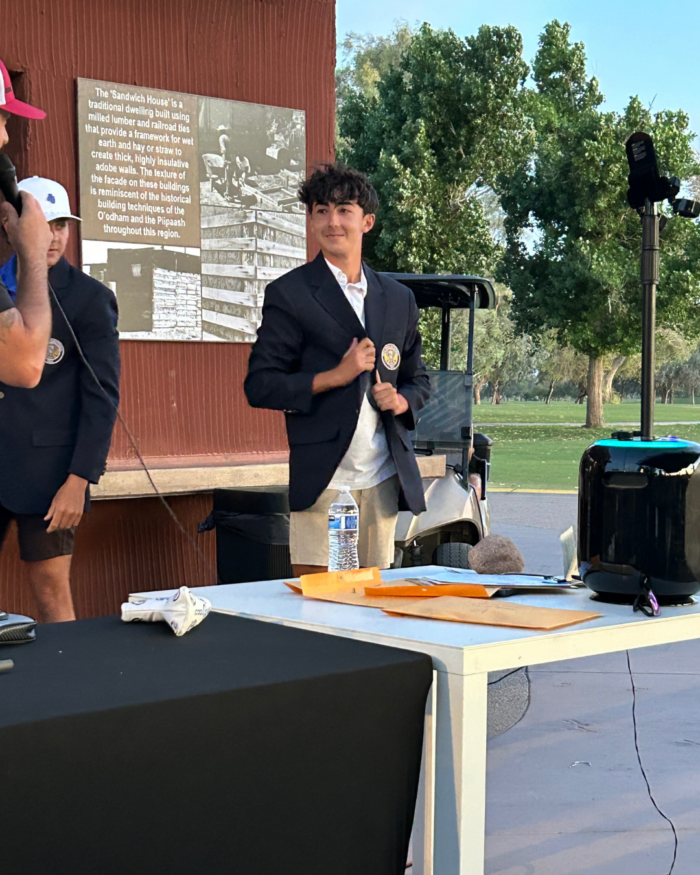 Golf Invitational winner receiving his navy jacket