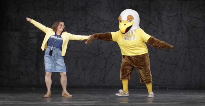 Headmaster dancing with Golden Eagle Mascot