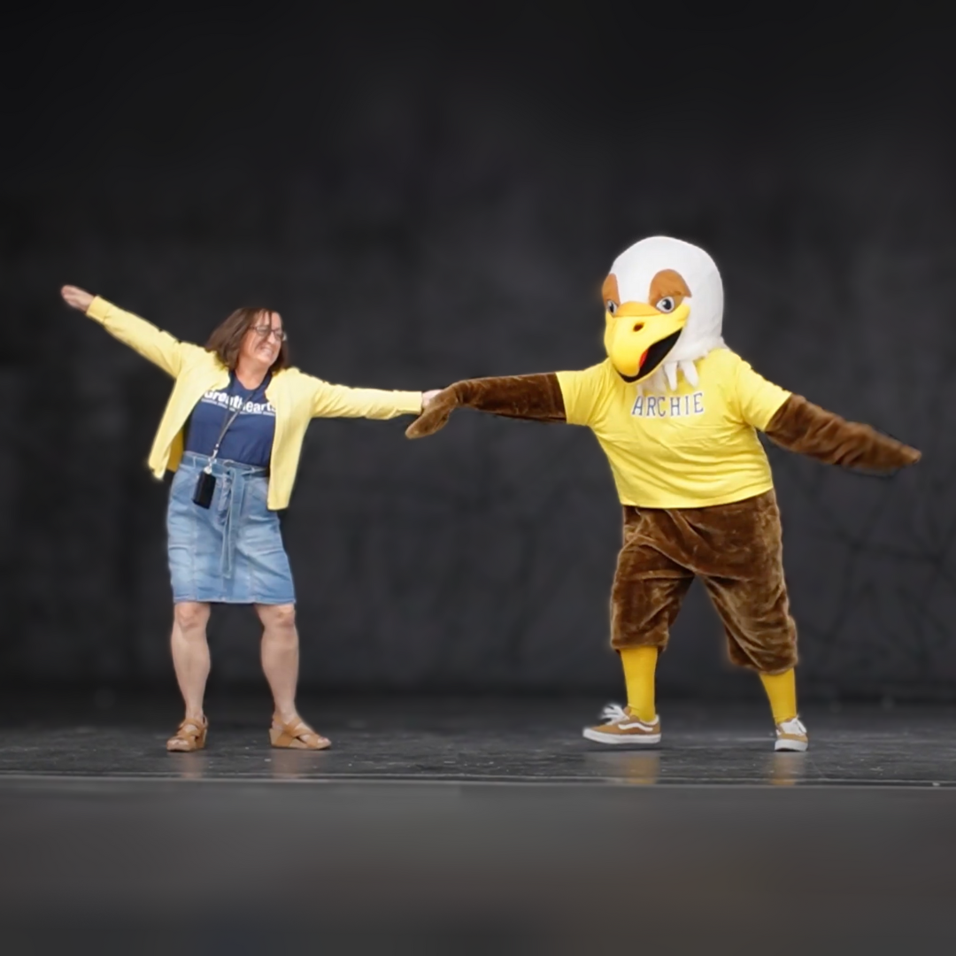 Headmaster dancing with Golden Eagle Mascot