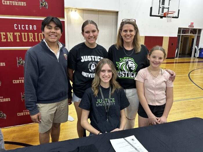 Student-athlete going to Justice University posing with her family