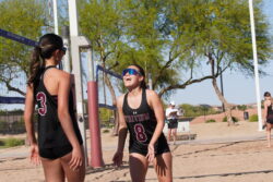 Two beach volleyball players on a sand court