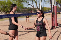 Two beach volleyball players on a sand court
