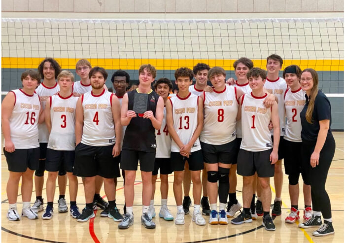 Cicero boys volleyball team posing in front of a net