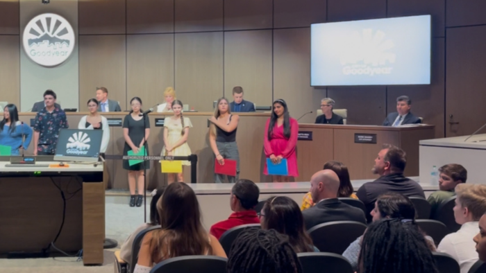Students standing in city counsel chambers