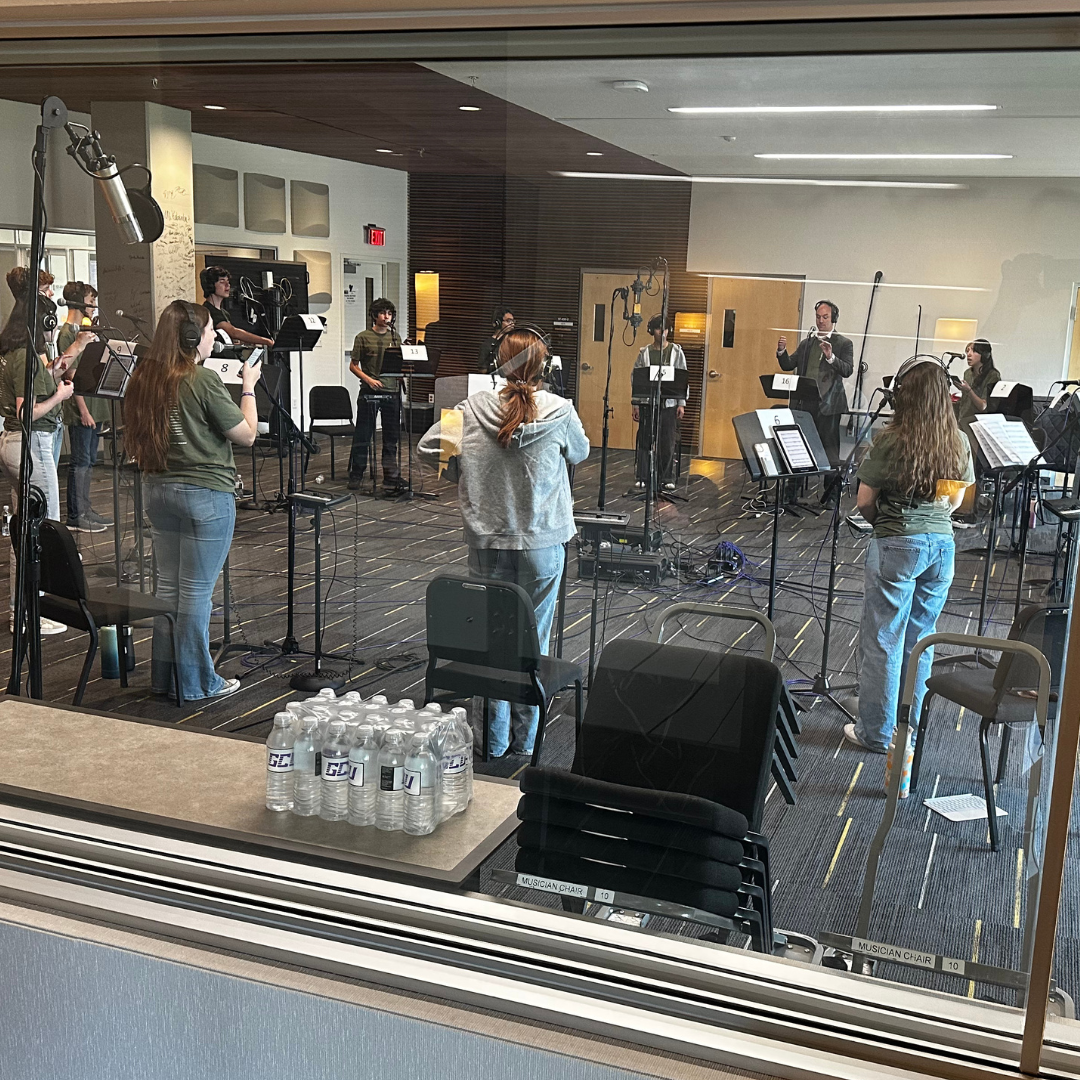 Students recording in a sound booth
