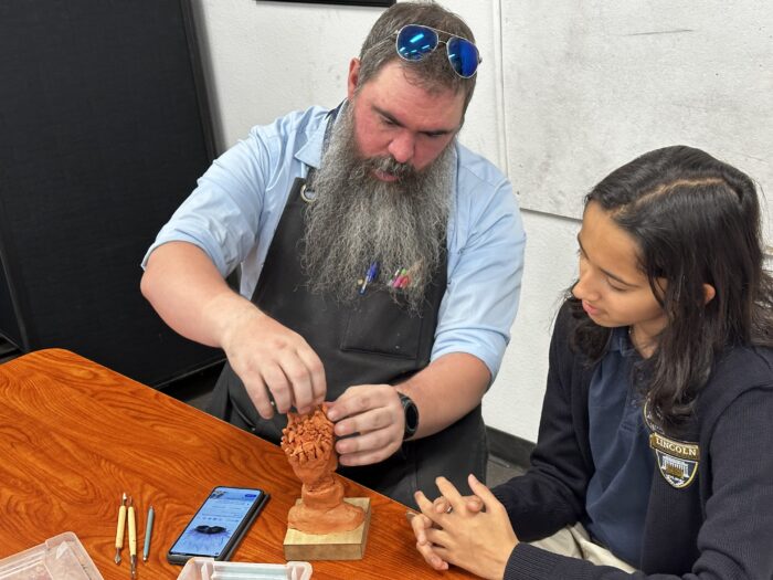 Instructor teaching sculting to a student