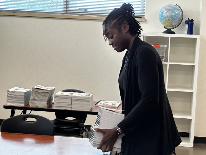 Teacher setting out books