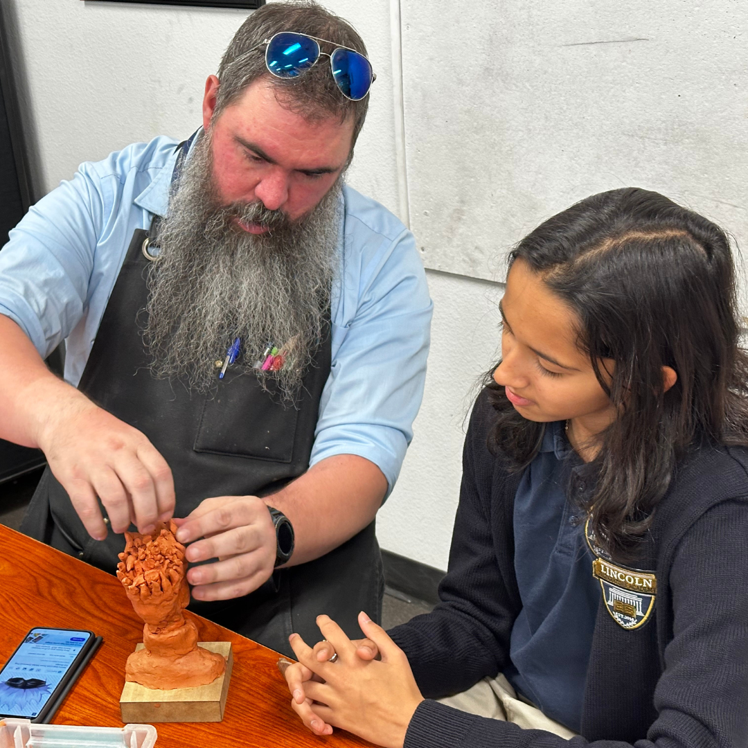Instructor teaching sculting to a student