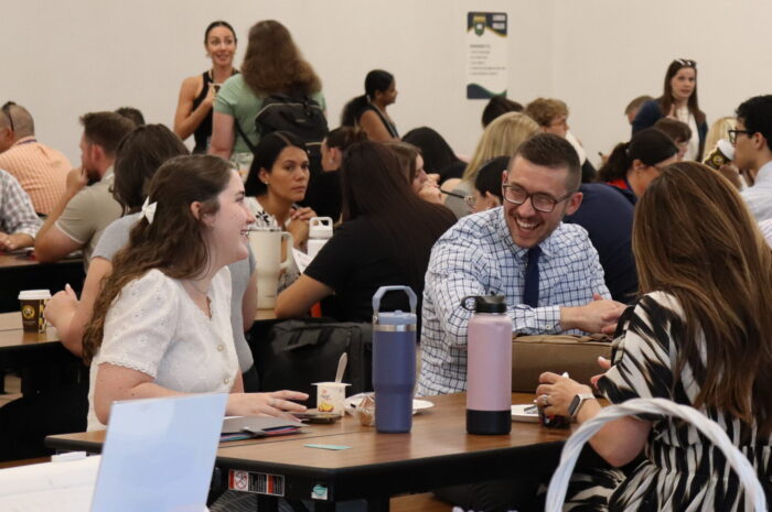 People laughing at a table at NFO
