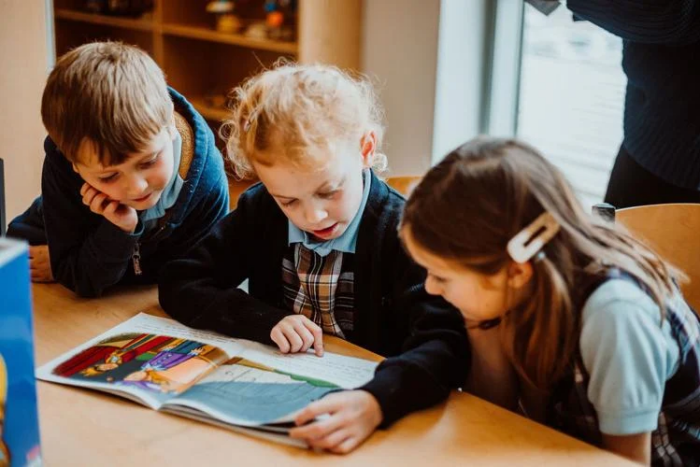 Students reading a book together
