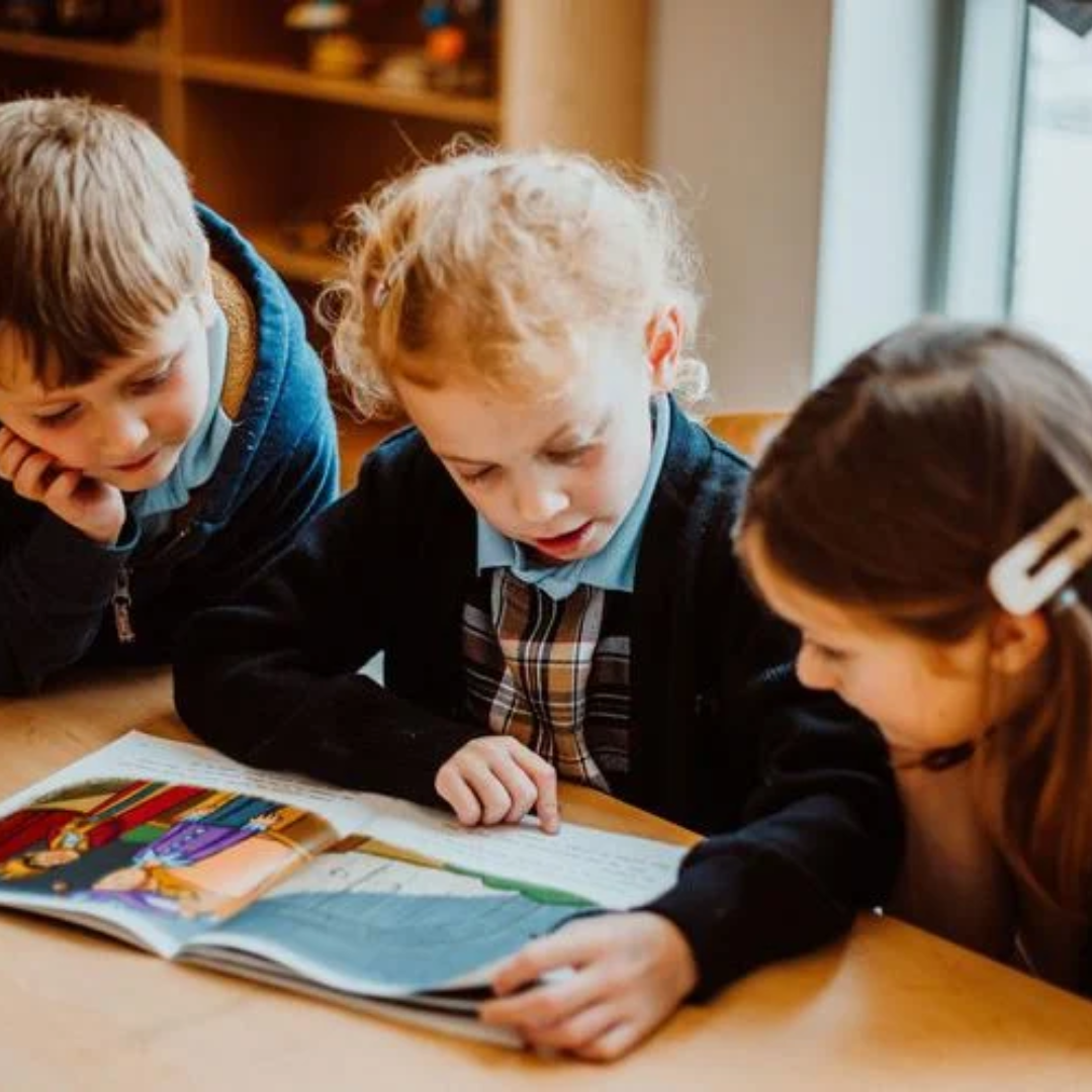 Students reading a book together