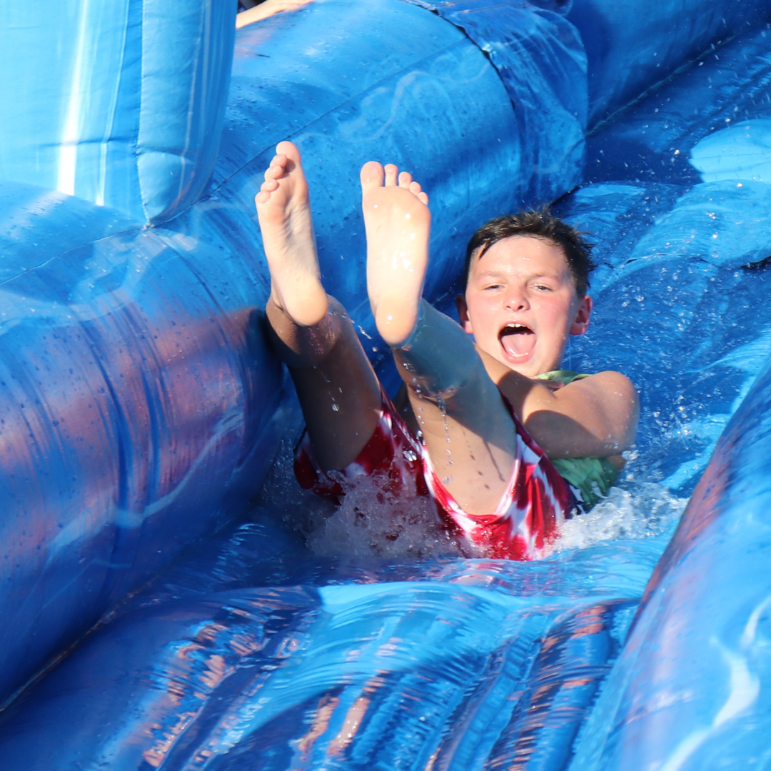 boy going down water slide