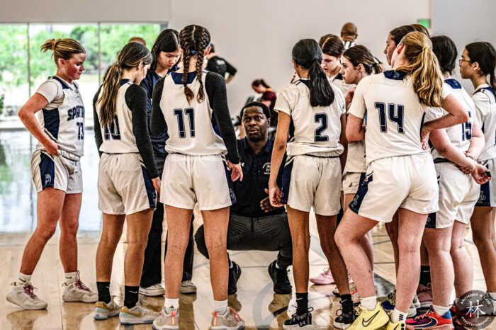 Coach with girls basketball players