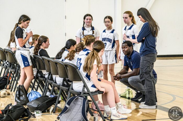 Coach with girls basketball players